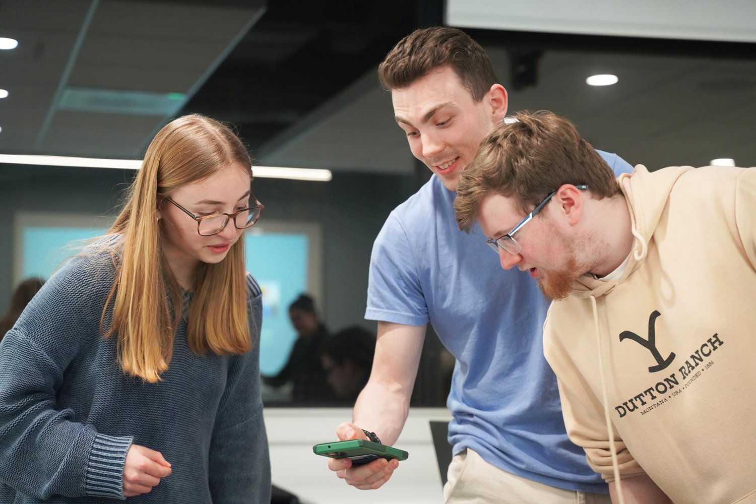 Riley King engages with two Computer Science and Scripting Club members.