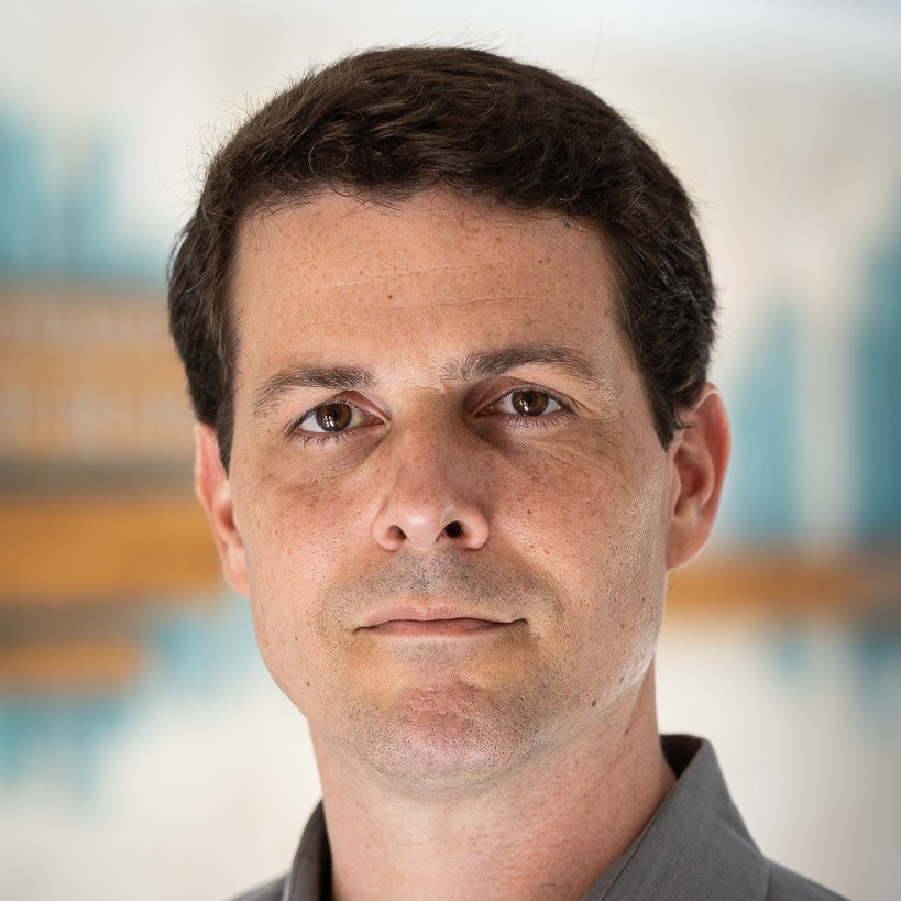 Headshot of Bernardo Motta, man with gray collared shirt.