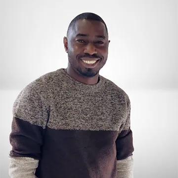 Headshot of Jimoh Fatoki, man wearing a gray and black sweater.