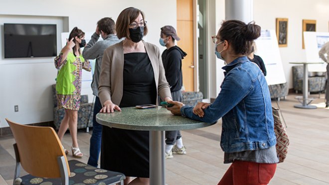 image of RWU Provost Margaret Everett talking with a student at SASH