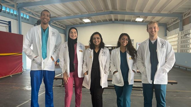 RWU graduate Matthew Kowalczyk works alongside peers to conduct screenings on underprivileged youth in the Caribbean.