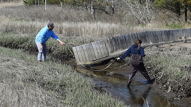 Students taking measurements for new foot bridge.