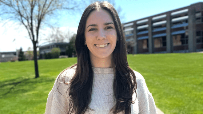 A photo of Rachel Borzone in front of the Cummings School of Architecture quad. 
