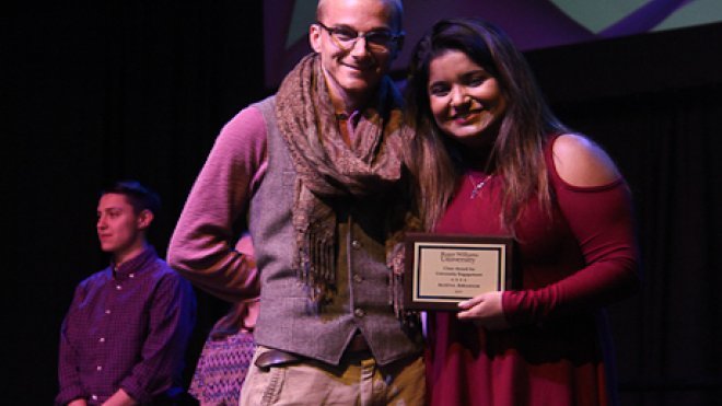 Student and staff member pose with award.