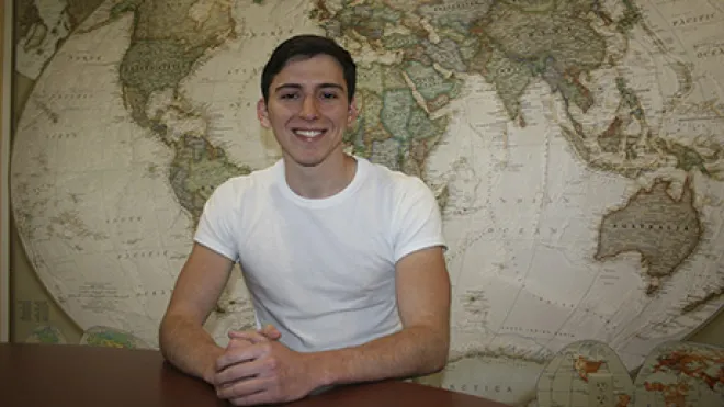 Anthony Salazar sits inside a classroom