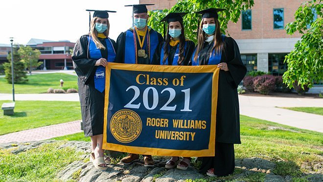 RWU class officers hold the Class of 2021 banner on the quad.