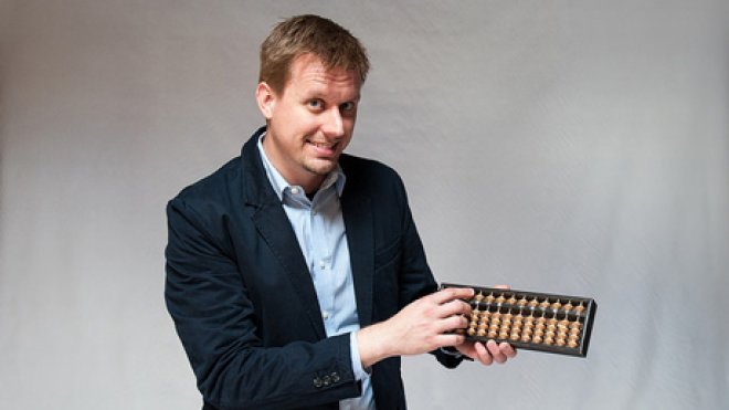 Professor Robert Jacobson with an abacus.