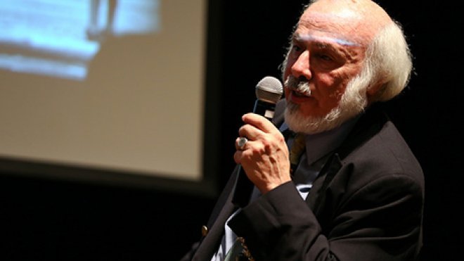Lecturer speaks to audience.