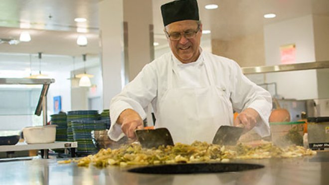 Chef prepares food in Upper Commons.