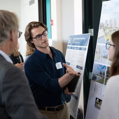 A student presenting his project to colleagues 