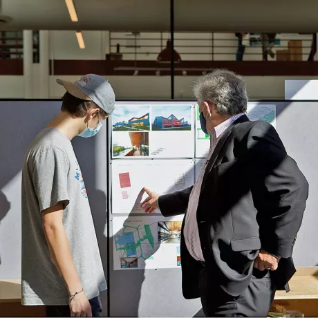 A student and a Dean discussing their project in studio