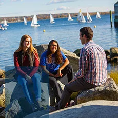 Students sitting by the water.