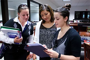 Students in a library seeing a book