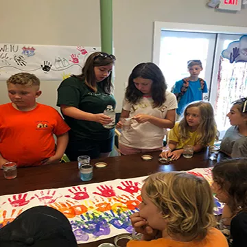Campers and director work on a project.