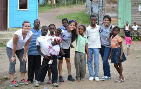 Students pose with children in a Haitian village