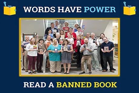 A group of faculty members hold up books.