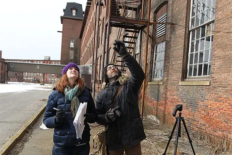 Historic preservation students examine unique characteristics of a former mill in Pawtucket.