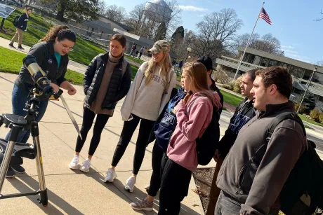 Professor shows students planet Mercury through solar telescope
