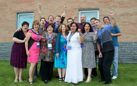 Alumni take a photo on campus