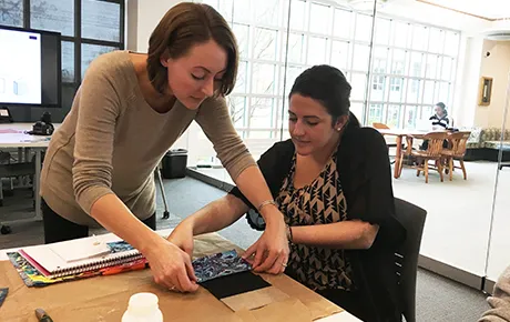 Professor teaches student bookbinding