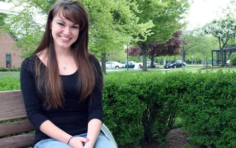 Student sits on university quad