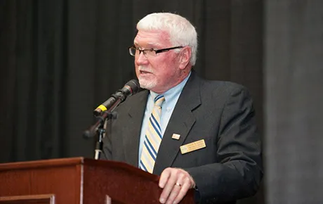 Man speaks at podium