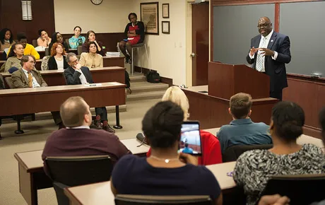 Lecturer speaks to students.