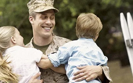 Soldier holding two boys