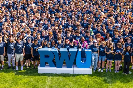 Group of students posing with RWU sign