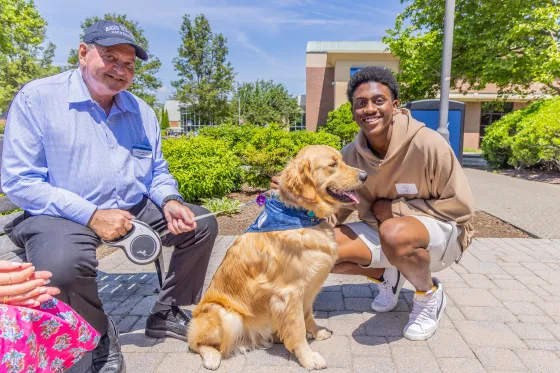 RWU president, his golden retriever and a student