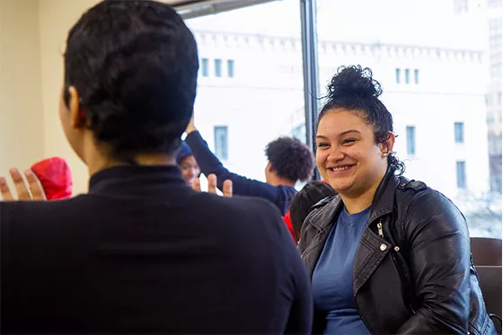 Student smiling at another student