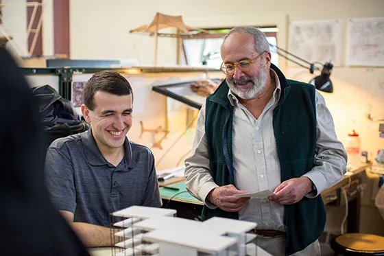 A student working with a professor.