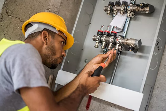 Plumber working on a valve