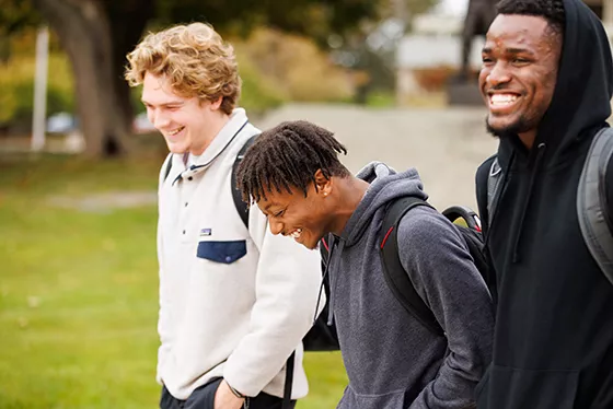 Three students walk together across RWU's Bristol campus