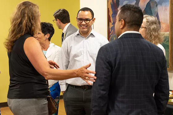 Group of happy people talk on Providence campus