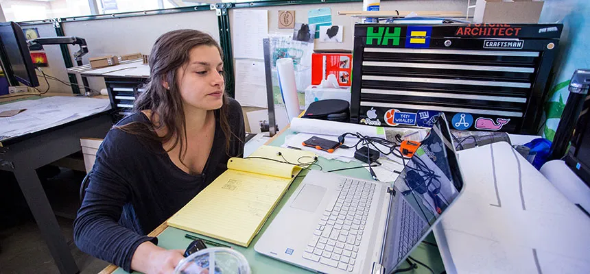A student sitting at a design studio desk.