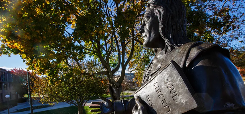 image of a close-up of Roger statue on fall day on RWU's Bristol campus