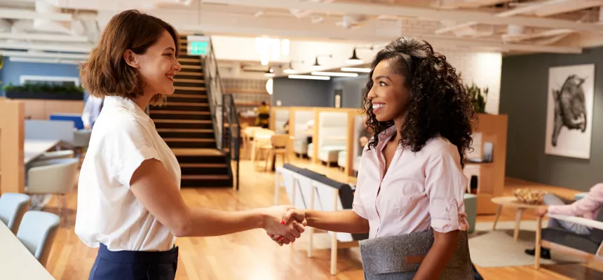 Women business students shake hands