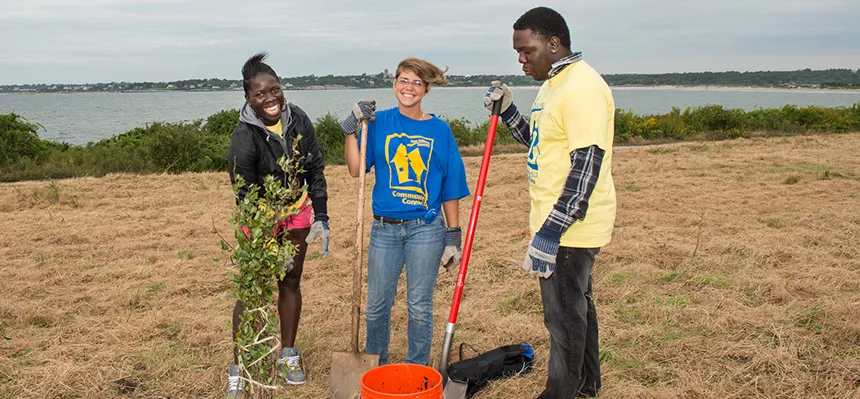 Students work outdoors on a community engaged project.