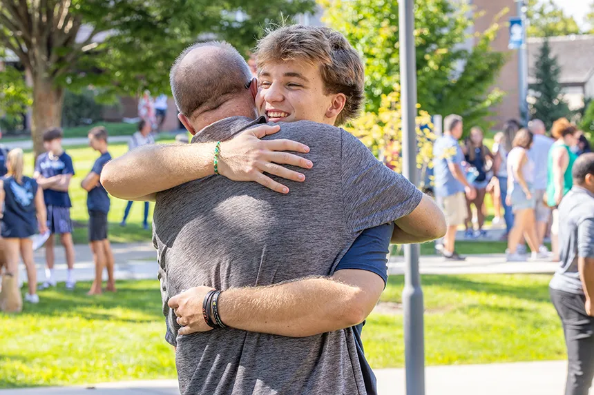 A new student embraces a family member following the Convocation ceremony.