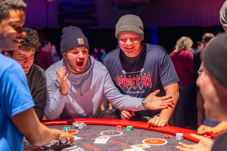 Two students are excited at the blackjack table.
