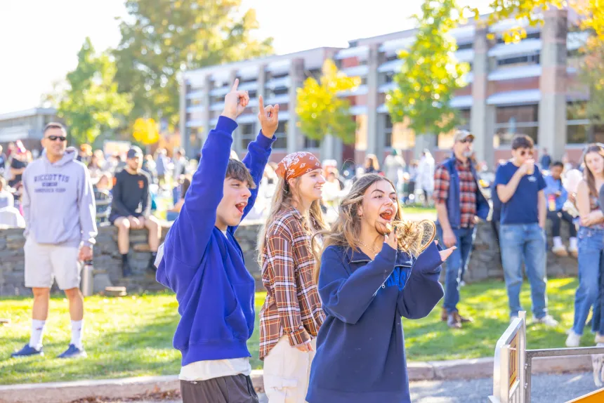 With fists in air, attendees show their joy playing a game during the Autumn Festival.