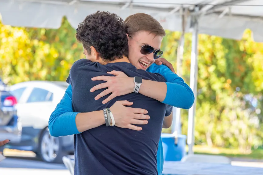 Two students hugging.