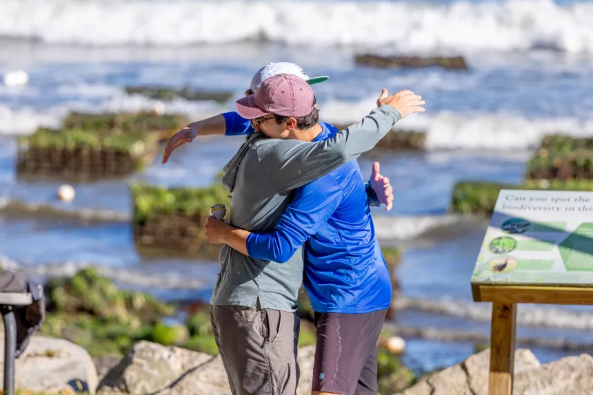 Two people hug.