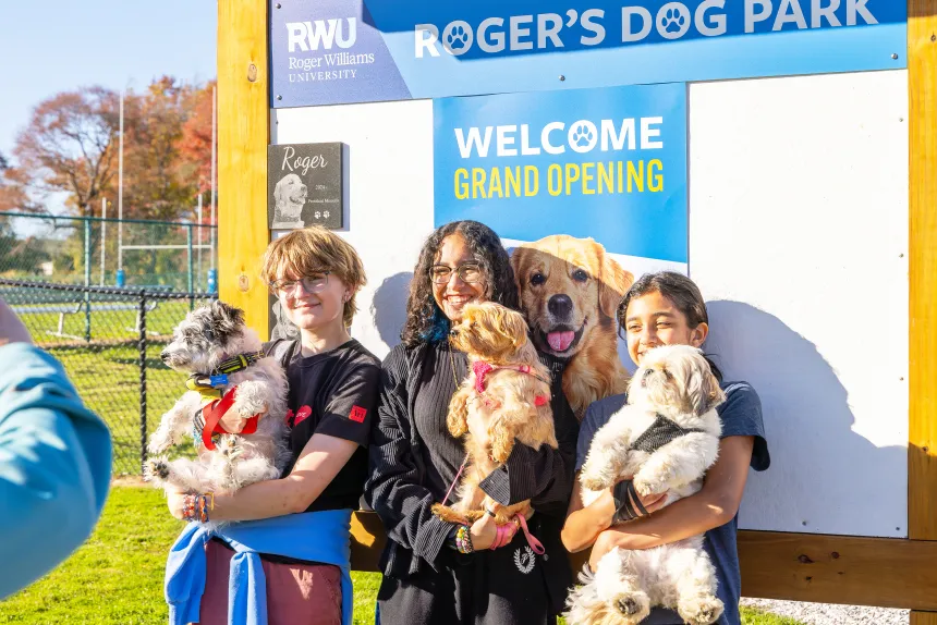 Student pose at the entrance of the Roger's Dog Park.