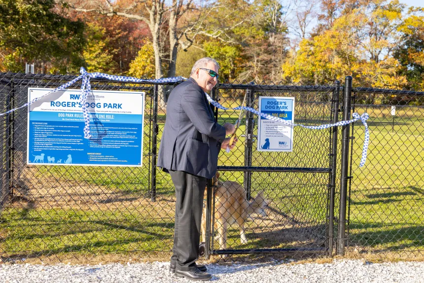 President Yannis cuts the ribbon for Roger's Dog Park.