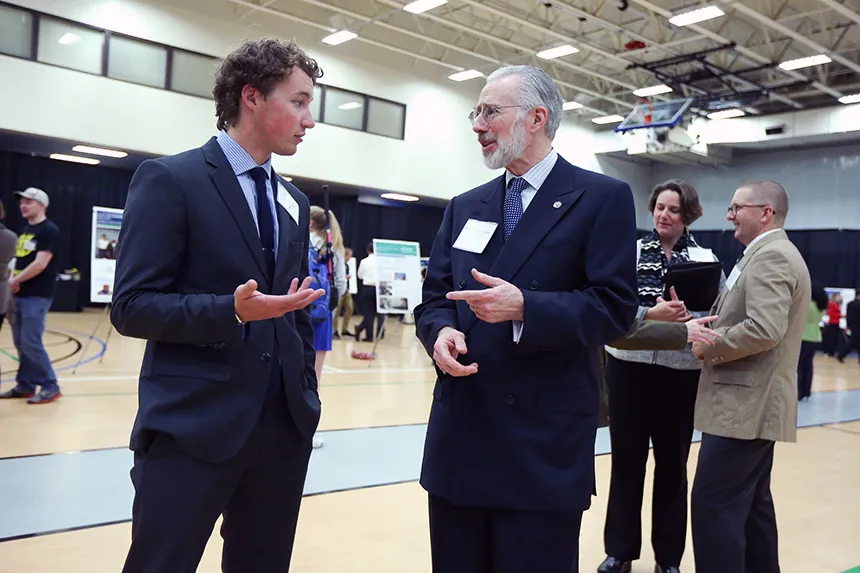 President Farish speaks with a student.