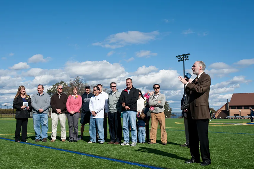 Parents and donors join President Farish to celebrate the installation of the new turf field.