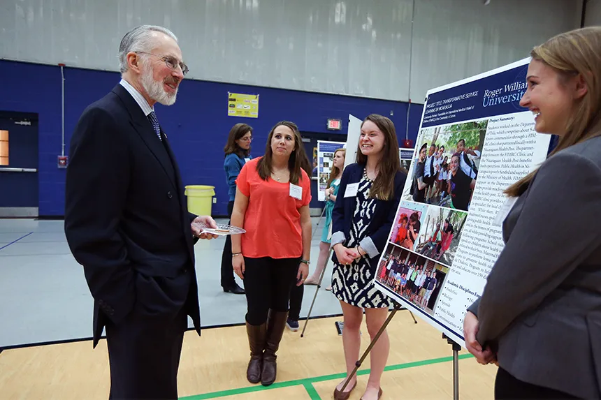 President Farish speaks to students about their work.