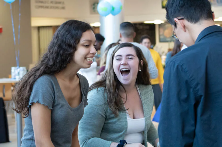 A group of students talking and laughing.